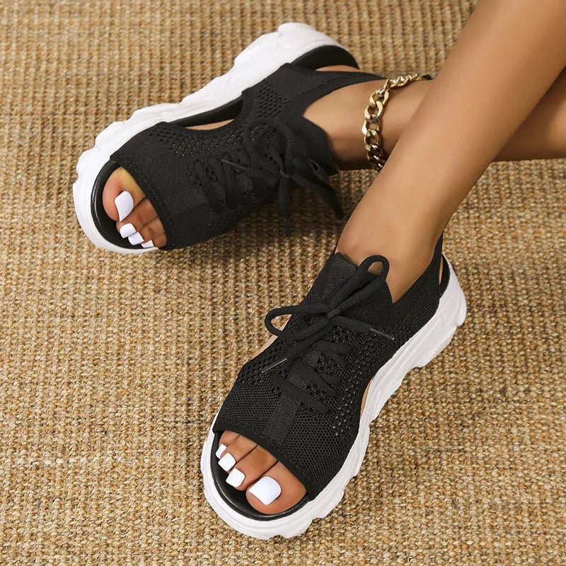 Women's black knit platform sandals with lace-up front and cushioned sole