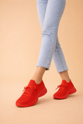 Women's red slip-on knit sneakers with cushioned sole