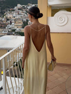 Women's light yellow satin slip maxi dress with fluid drape