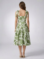 Women's green floral a-line dress with fitted bodice and flared skirt