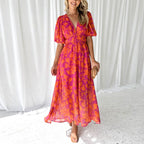 Women's floral maxi dress with deep v-neck and flowing skirt