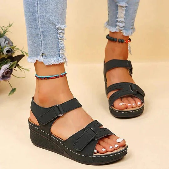 Women's black walking sandals with adjustable twin straps and flat footbed
