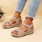 Women's beige walking sandals with adjustable twin straps and flat footbed