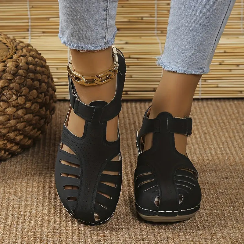 Women's black closed-toe wedge sandals with ankle strap